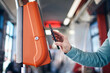 Leinwandbild Motiv Man buying ticket via digital wallet. Contactless paying for public transportation with mobile phone..