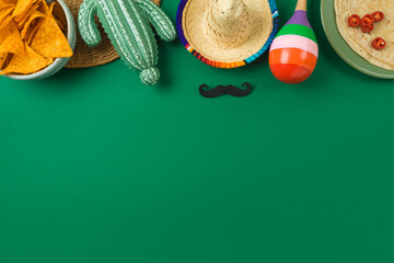 Cinco de Mayo holiday background with Mexican cactus, nachos chips, maracas and party sombrero hat. Top view, flat lay