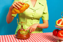 Female Hand Tasting Crispy Croissant On Plaid Tablecloth Isolated On Bright Blue Background. Vintage, Retro Style Interior. Food Pop Art Photography.
