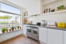 Kitchen Near An Open Window With Aromatic Plants