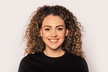 Smiling Blonde Woman With Curly Hair In Studio