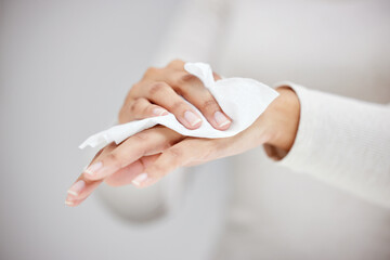 Poster - Wiping the germs away. Shot of an unrecognizable person using a wipe to clean their hands.