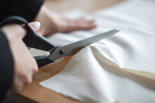 Female Tailor Hands Using Scissors To Fabric, Selective Focus, Natural Light