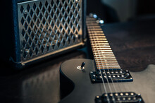Close-up, Black Electric Guitar On A Dark Background.