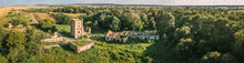 Aerial View Remains Of Yastrzhembsky Estate And Park Complex. Top View Of Old Five-storey Brick Water Tower. Drone View Of Beautiful European Nature In Summer Season. Bird's Eye View. Panorama