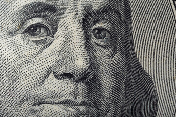 Portrait of Ben Franklin on the US 100 dollar bill in macro. Benjamin Franklin on hundred dollar American banknote.