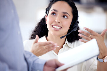 Wall Mural - sharing her input to find the best solution. shot of a young call centre agent talking to a colleagu