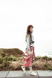 © Cavan Images - Natural beauty walks along hill joyously with ocean view