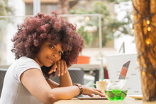 Young Afro Woman In A Coffee Shop Working Online