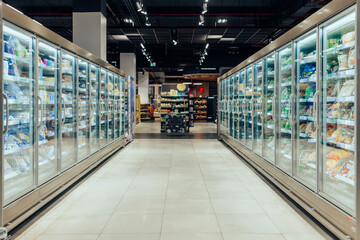 Wall Mural - Empty supermarket aisle with refrigerators