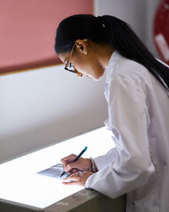 Canvas Print - Working on a suitable treatment for the dental problem. Cropped shot of a young female dentist analysing an x-ray.