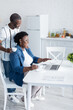 © LIGHTFIELD STUDIOS - positive and senior african american couple looking at laptop during video chat.