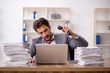 © Elnur - Young male employee unhappy with excessive work in the office