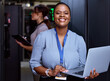 © Siphosethu Fanti/peopleimages.com - Ill have your servers performing optimally. Cropped portrait of an attractive young female programmer working in a server room with her colleague in the background.
