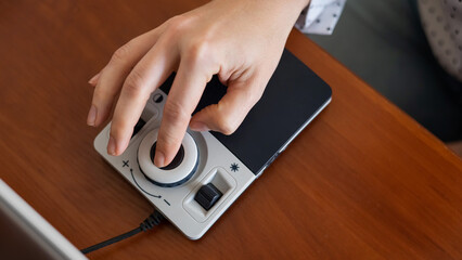 A woman uses a special magnification device for the visually impaired.