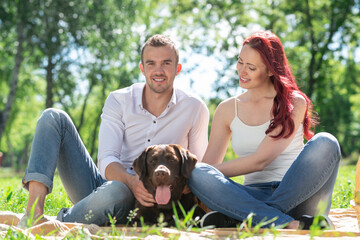 Canvas Print - Couple with a dog in the park