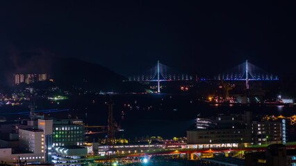 Canvas Print - Nagasaki, Japan. A night timelapse made from a hill in Nagasaki, Japan, with a view over the entire center, including the bay and the hills. Fireworks over the bay