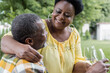 © LIGHTFIELD STUDIOS - happy and senior african american couple clinking glasses of wine.