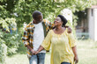 © LIGHTFIELD STUDIOS - happy senior african american couple walking in park.