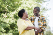 © LIGHTFIELD STUDIOS - happy senior african american couple looking at each other in green park.