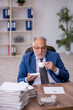 © Elnur - Old male employee drinking coffee during break