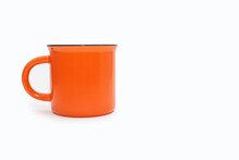 Orange Mug On A White Background With Free Space For Text. A Large Orange Cup With A Drink On A White Isolated Background. The Concept Of Drinking Hot Drinks. Bright Colorful Mug Image