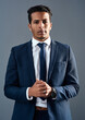 © K Seisa/peopleimages.com - Its just business. Studio shot of a corporate businessman posing against a grey background.