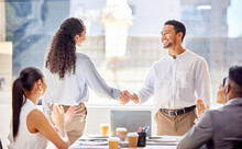 You Did A Sterling Job In The Latest Project. Shot Of Two Businesspeople Shaking Hands During A Meeting In An Office.