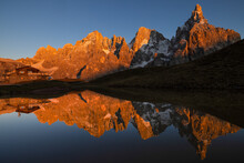 The Pala Group Reflected On An Ephimeral Lake As Seen From Passo Rolle At Sunset