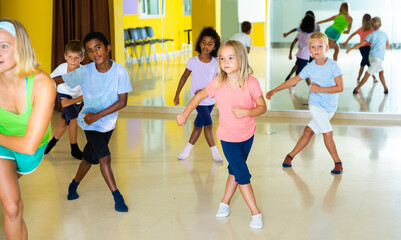 Wall Mural - Active young children posing at dance class. High quality photo