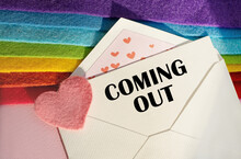 An Open Envelope With The TextI COMING OUT, On A Pink And Blue Background With A Decor Of Felt Hearts And A Flower. Flat Lay, Top View. LGBT Concept.