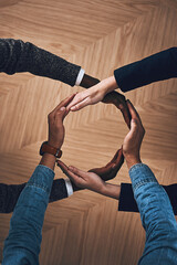 Poster - There is more power in unity than division. High angle shot of a group of unidentifiable businesspeople forming a circle with their hands.