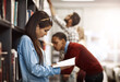 © Nikish H/peopleimages.com - This book has just what I need to complete my project. Shot of a university student reading a book in the library at campus.