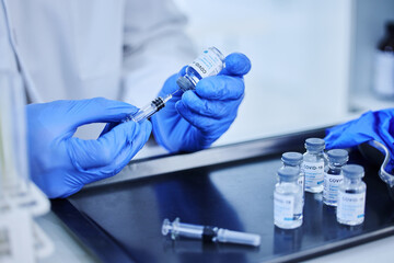 Wall Mural - its time to get vaccinated. cropped shot of an unrecognizable scientist using a syringe to extract t