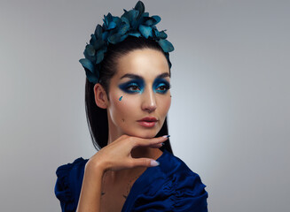 Wall Mural - Natural beauty, enhanced by makeup. Studio shot of a beautiful young woman looking thoughtful while posing against a grey background.