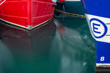 Details Of The Water Line For Two Large Fishing Boats Are Blue, White, And Red Colored.  The Boats Are Blue, White, And Rusty Red Colored With White Numbers Identifying A Water Line Up To 8 Meters.  