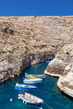 Maltese Boats On Transparent Green Water Of Wied Zurrieq Fjord Of Malta Island