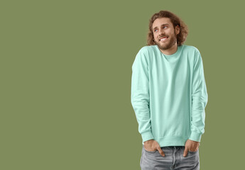 Sticker - Smiling young man in sweatshirt on green background