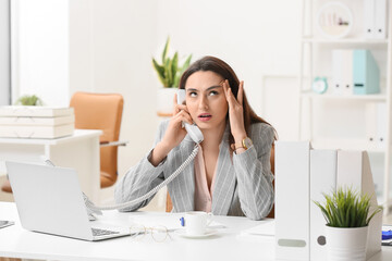 Poster - Young annoyed secretary talking by phone in office