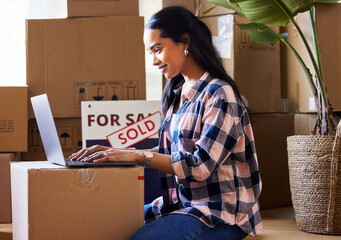 Change is good, so embrace it. Shot of a young woman packing up to move.