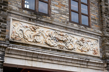 Close-up of ancient building exterior walls and plants in a Chinese style garden