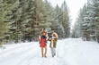© pressmaster - Happy African American man, his wife and son having stroll in fresh air on frosty winter day among coniferous trees covered with snow