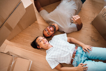 Sticker - We can finally create the home weve always wanted to. Shot of a happy couple lying on the floor together in their new home.