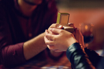 Canvas Print - The perfect ring for the perfect moment. Cropped shot of a man proposing to his girlfriend with an engagement ring in a box.