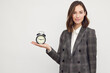 © Martin Villadsen - Young businesswoman holding a clock or an alarm in her hand palm. Concept: Having a deadline. Isolated on white background with copyspace.