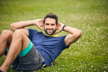 Wall Mural - Theres nothing boring about exercise. Shot of a sporty man doing sit-ups.