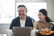 Asian Middle-aged Asian couple laughing together at home
