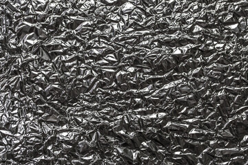 Abstract background shimmering texture metallic glitter foil. Crumpled foil as an unusual background.