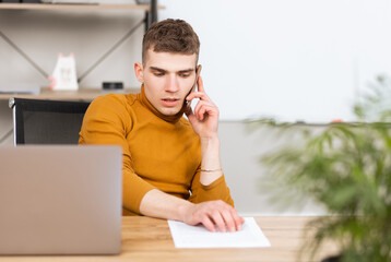 handsome young man working with documents in the office