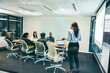 Leinwandbild Motiv Businesswoman giving a presentation to her colleagues in an office